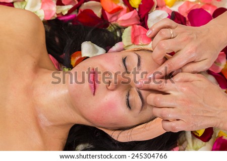 Beautiful woman in salon.Spa therapy for young woman receiving facial mask at beauty salon - indoors.Cosmetology, beautician, beautiful background - concept of a facial care.