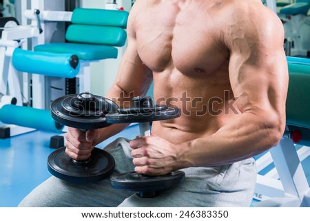 The process of power exercise. Sports. The process of exercises with dumbbells. Healthy lifestyle concept. Fitness, bodybuilding, strength, youth, health.