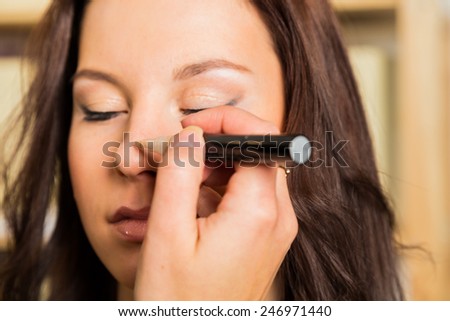 Makeup artist paints the eyebrows model. painting of eyebrows