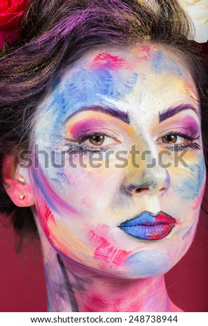 The creative, bright, color makeup. Piercing look. Floral makeup. Beautifully painted lips and eyes. Tone, powder, make-up. Multi-colored roses in her hair girl.