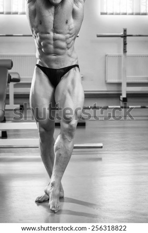 Athletic man showing muscles in suspense