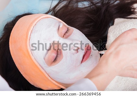 Facial massage. Cosmetic procedures facial massage. Girl in spa salon. Cosmetic facial treatments.
