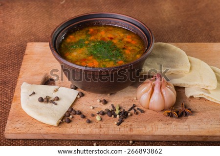 Oriental soup. Eastern food with different spices and bread on wood isolated on vintage background