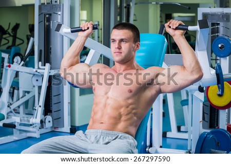Handsome muscular male body. Male bodybuilder. Muscles of the arms, torso, abdominal muscles. Bodybuilding pose. Concept l bodybuilding.
