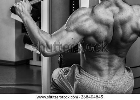The process of physical exercise . The man is engaged in the gym. Training in the gym. Healthy lifestyle. Photo in creative.
