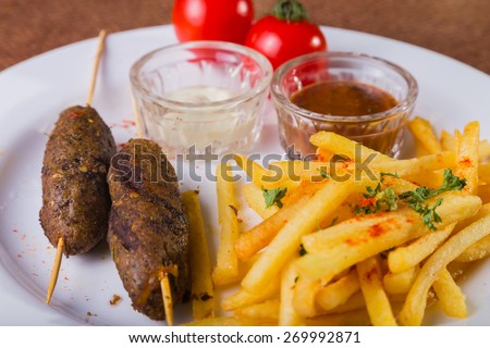 Tasty food. French fries with meat.