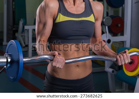 Sexy, blonde, doing fitness in the gym. Female fitness. Girl with perfect body in the gym.