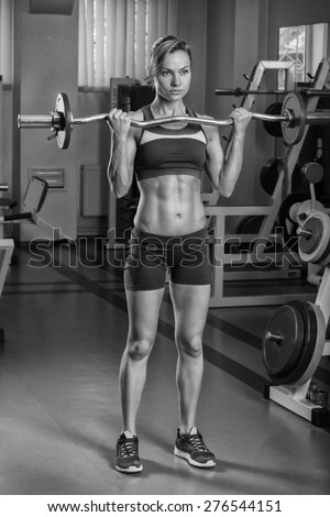 Sexy blonde trains his muscular body in the gym. Sport blonde. Strong girl.