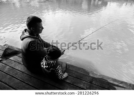 Father and son fishing. Fishing on the lake. AREA fishing. Trout fishing. Active family vacation. The relationship between father and son.