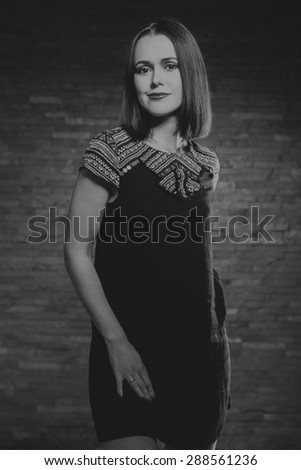 Portrait of a beautiful, charming brunette. Black and white photography. Fashion photography.