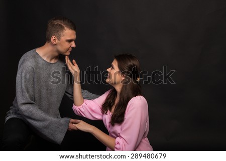 Lovers man and woman. Emotions and feelings. A guy and a girl on a black background. Love and tenderness.