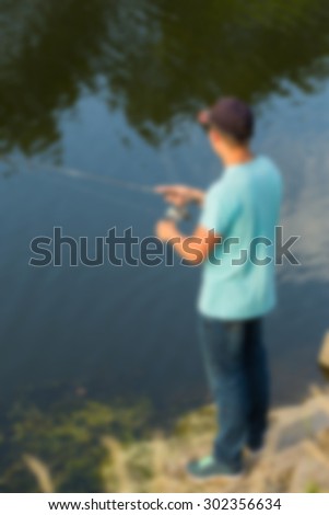 A fisherman on the river, fishing. blurred Background