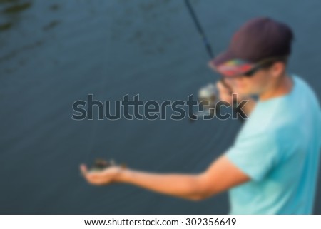 A fisherman on the river, fishing. blurred Background