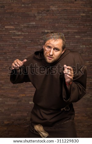 Image feeble man. The actor plays the role of a poor feeble. Sorrow and despair in the eyes of man. Medieval cassock and other accessories to the actor.