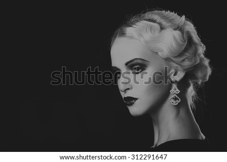 Beautiful blonde on a dark background. Portrait photo. A beautiful dress and accessories. Professional makeup. Beautiful model image lady 20s years.