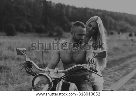 Beautiful couple in love on the chopper. Love is feeling, passion, traveling. Traveling alone, love.