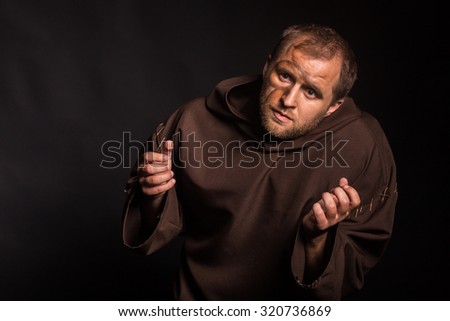 Image feeble man. The actor plays the role of a poor feeble. Sorrow and despair in the eyes of man. Medieval cassock and other accessories to the actor.