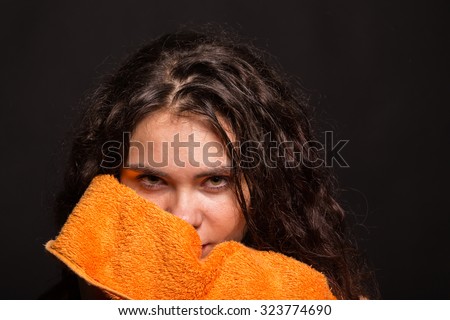 Portrait photo athletic girl. Beautiful girl after an exhausting workout. She rubbed the towel. The image of hardworking and dedicated purpose of man.