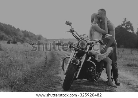 Beautiful couple in love on the chopper. Love is feeling, passion, traveling. Traveling alone, love.