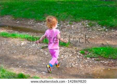 running away small child on the earth road