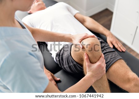 Similar – Image, Stock Photo Physiotherapist stretching leg of patient in medical room