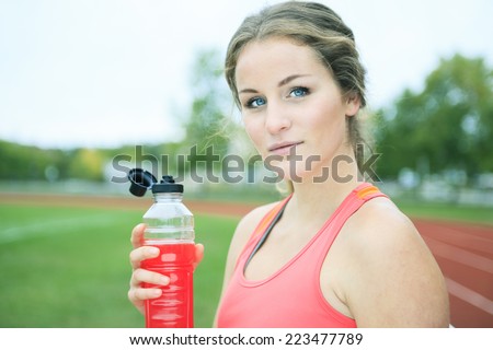 Drink young woman jogging track