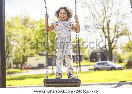 Similar – Image, Stock Photo 4 year old blonde girl with a brightly colored striped sweater sits at a wooden table and draws with a purple pencil on a piece of white paper