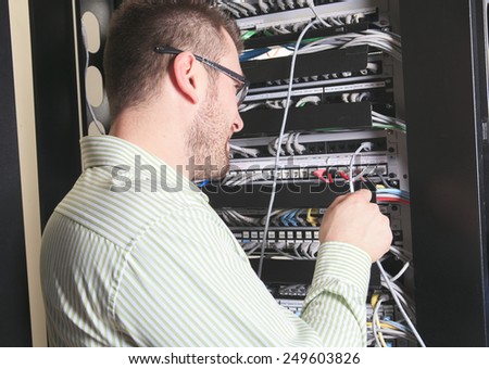 A happy worker technician at work with computer
