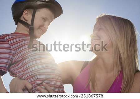 Active family - mother and kid having fun, rollerblading outdoor on a sunny summer day