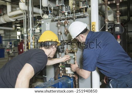 repairman engineer or inspector who check the system.
