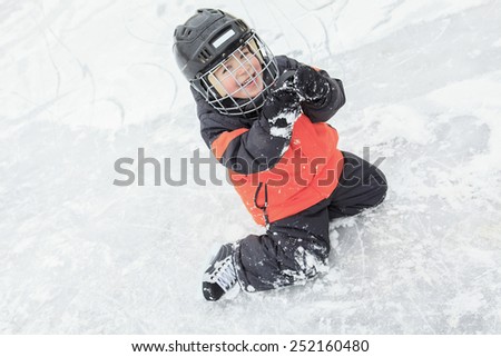 A portrait of happy child in winter play hockey