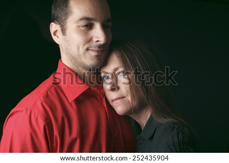 A 30 years old couple in front of black background