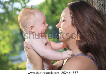 A mother with is baby on a beautiful forest