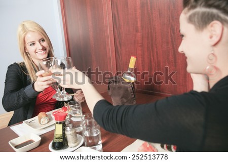 Two girl friends  in a sushi restaurant
