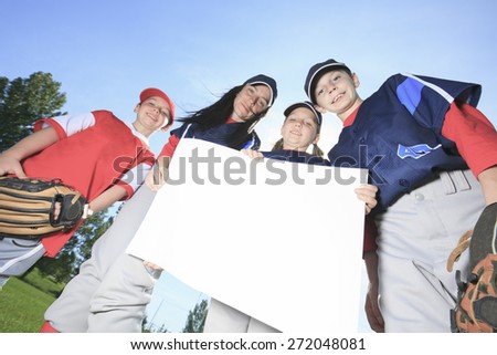 A Baseball team holding a white dardboard