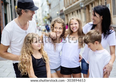 A Summer family portrait of parents and kids outside in urban style