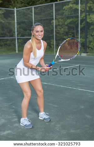 A woman tennis player having fun to play this game.