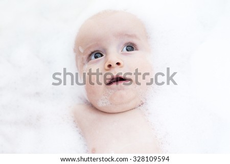 A Toddler showing face just above water surface.