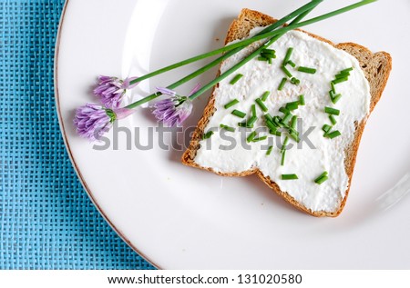 slice of bread with cream cheese and chives