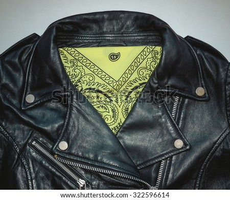 biker black leather jacket and yellow bandana. Photo with vintage toning and vignette