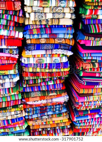 Columns of folded colorful blankets in bolivian street market, La Paz, Bolivia