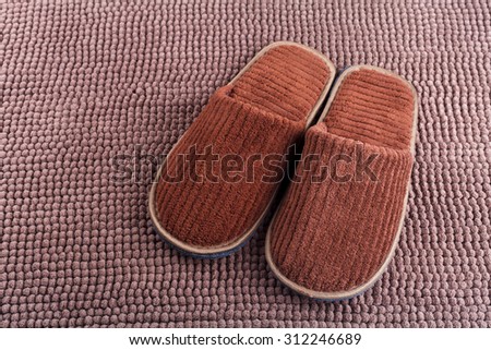 Brown wool slipper on mat