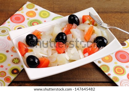 Esqueixada, a traditional Catalan salad with shredded salt cod, tomatoes, onions and black olives