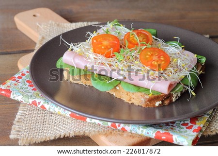 Toast with spinach, ham, alfalfa sprouts and cherry tomatoes