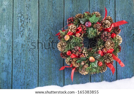 Christmas wreath on an old wooden door with space for text