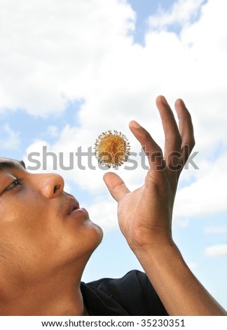 Man blowing flying round flower in nature