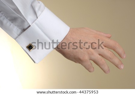 man arm with shirt at the beige with cuff link
