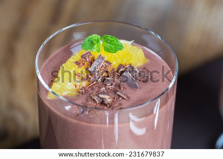 Chocolate pudding dessert with orange and grated chocolate.