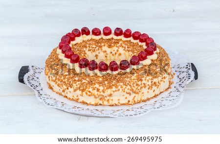 Frankfurt crown cake with cherries on white wooden.