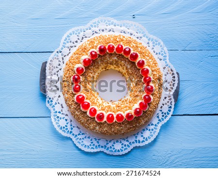 Frankfurt crown cake with cherries on a blue wood